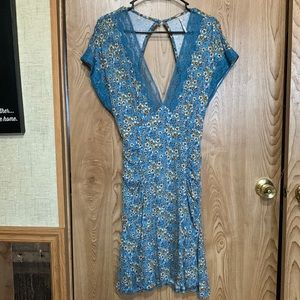 Free People Size Medium mini floral dress. Deep V neck, open back, ruched sides.